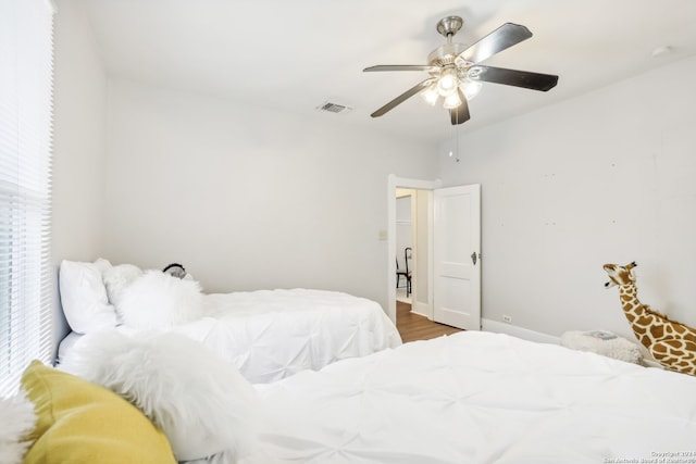 bedroom with hardwood / wood-style flooring and ceiling fan