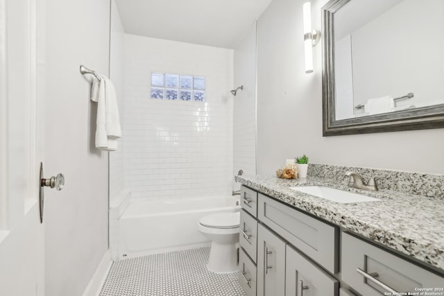 full bathroom featuring vanity, toilet, tile patterned floors, and tiled shower / bath