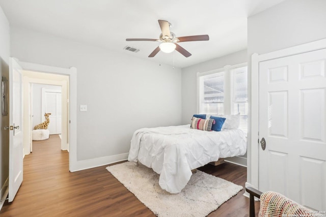 1112 W Huisache Ave, San Antonio, TX 78201 - bedroom with baseboards, a ceiling fan, dark wood-type flooring, and visible vents