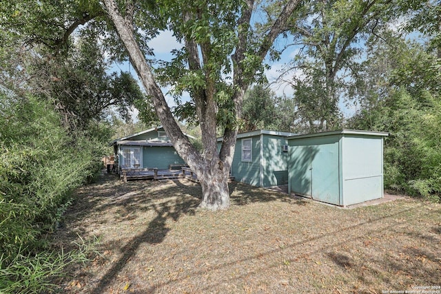 1112 W Huisache Ave, San Antonio, TX 78201 - back of house featuring a wooden deck and an outbuilding