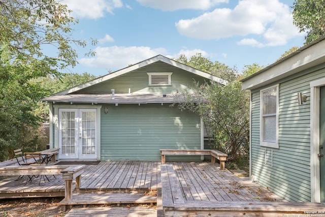 rear view of property featuring french doors and a wooden deck