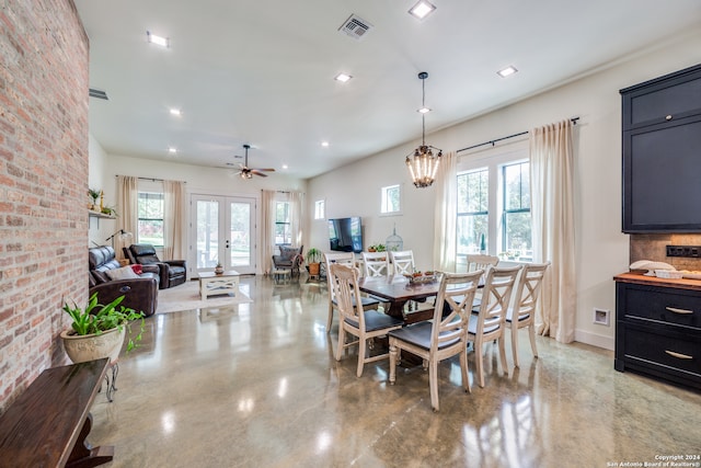 dining area with french doors and ceiling fan with notable chandelier