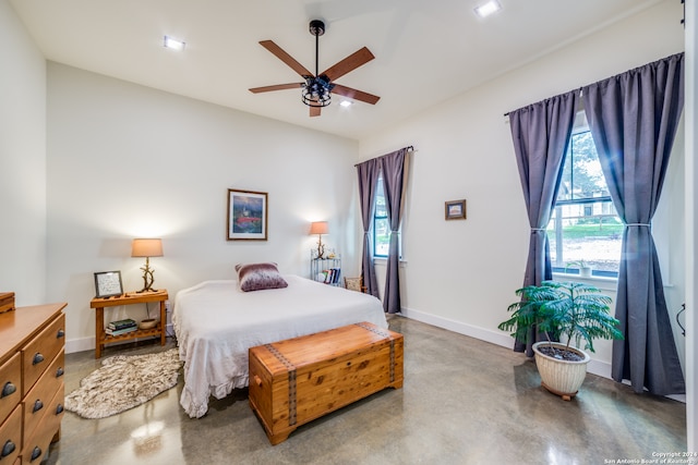 bedroom with ceiling fan and concrete floors