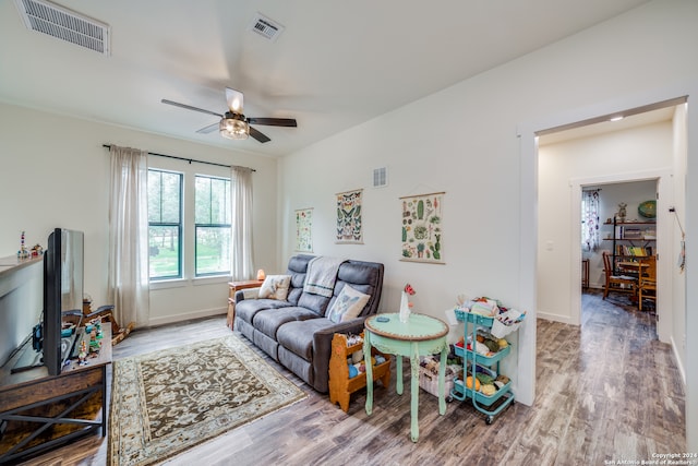 living room featuring hardwood / wood-style flooring and ceiling fan