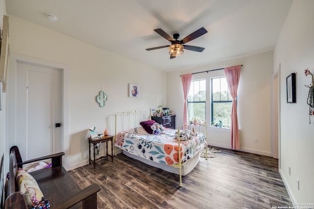 bedroom with dark hardwood / wood-style floors and ceiling fan