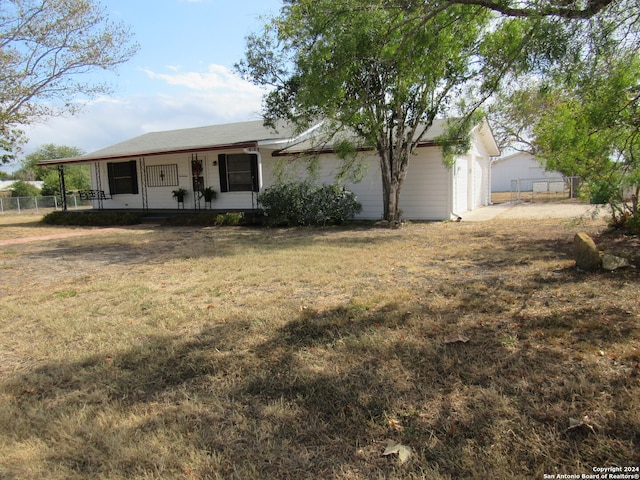 view of front of home featuring a garage, a front lawn, and a porch