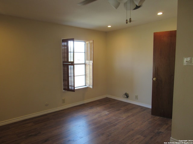 unfurnished room with ceiling fan and dark hardwood / wood-style floors