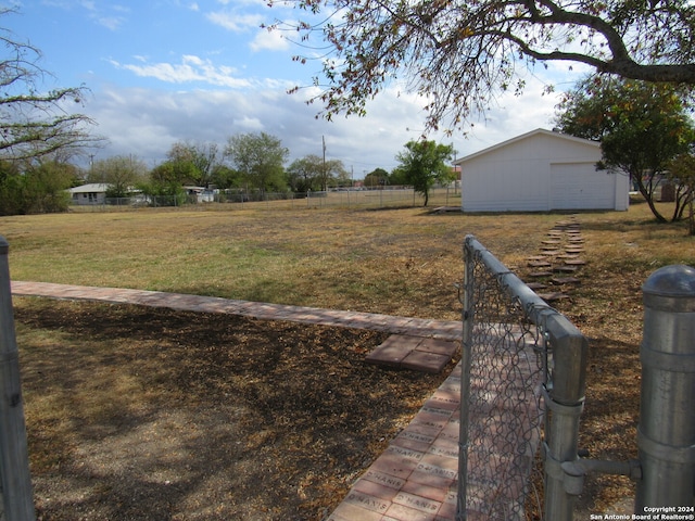 view of yard with a garage and an outdoor structure