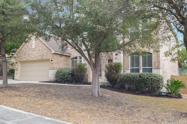 obstructed view of property with a garage