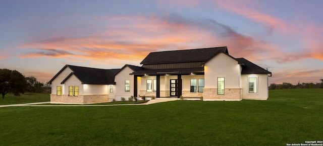 back house at dusk with a yard