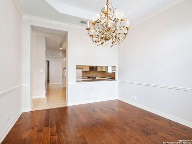 interior space with crown molding, a chandelier, and light wood-type flooring