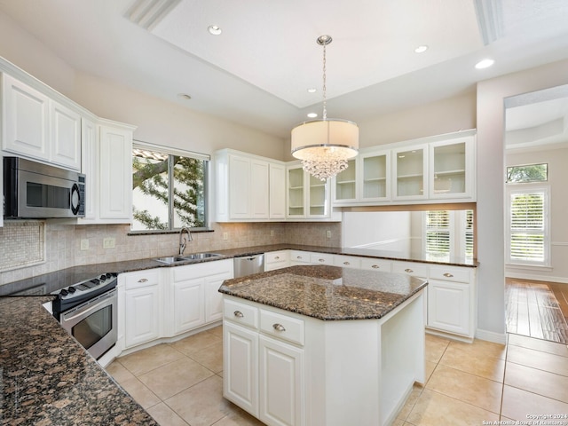 kitchen featuring white cabinetry, a healthy amount of sunlight, appliances with stainless steel finishes, and sink