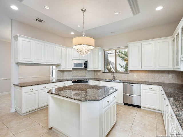 kitchen with sink, appliances with stainless steel finishes, and white cabinets