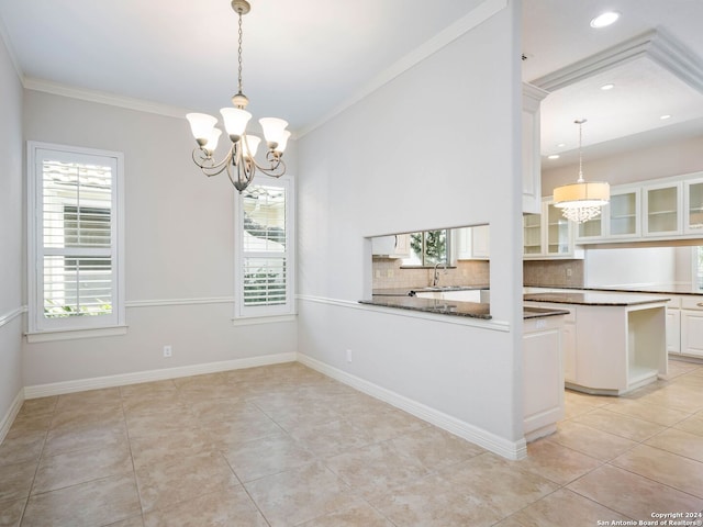 unfurnished dining area featuring an inviting chandelier, ornamental molding, and light tile patterned flooring