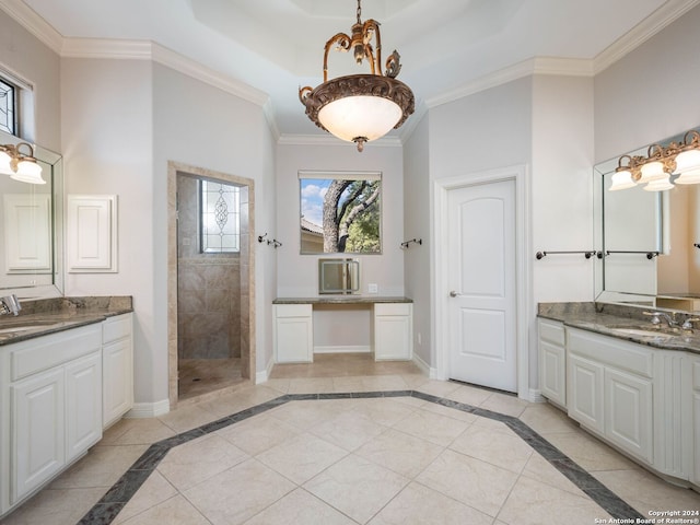 bathroom with vanity, tiled shower, ornamental molding, and tile patterned floors