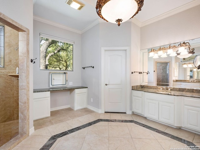 bathroom with vanity, a tile shower, ornamental molding, and tile patterned floors