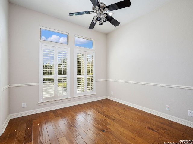 empty room featuring ceiling fan and hardwood / wood-style flooring