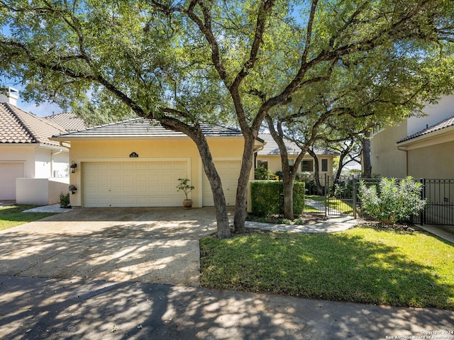 view of front of property with a front yard and a garage