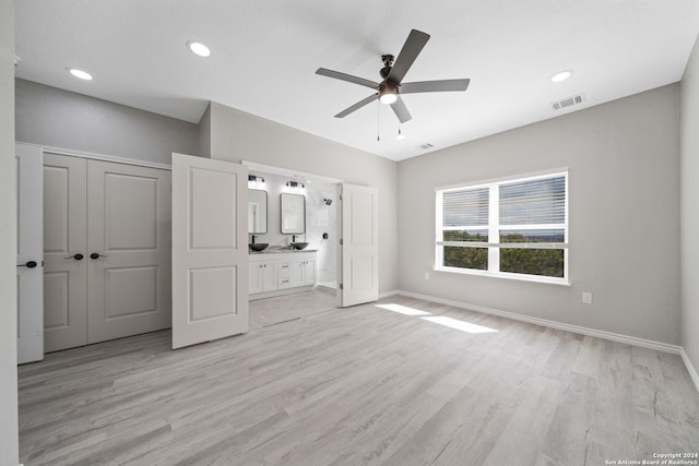 unfurnished bedroom with a closet, ceiling fan, light hardwood / wood-style flooring, and ensuite bathroom