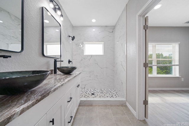 bathroom with vanity, hardwood / wood-style floors, and tiled shower