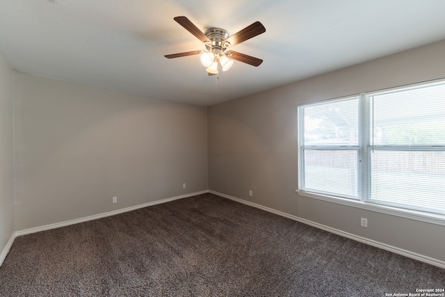 carpeted spare room with ceiling fan