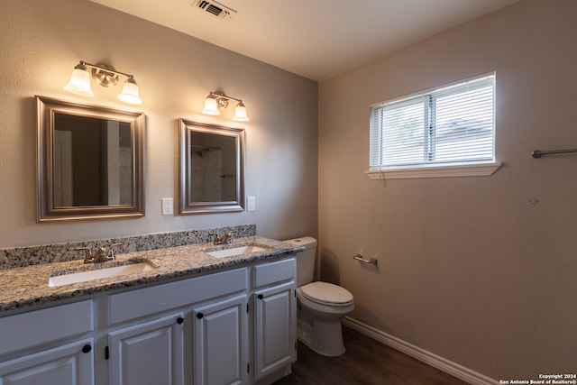 bathroom featuring toilet, hardwood / wood-style floors, and vanity