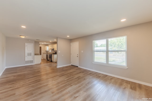 unfurnished living room with light wood-type flooring