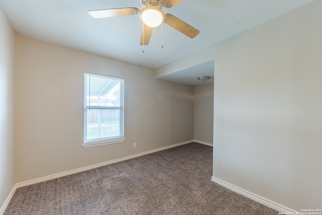 empty room featuring carpet floors and ceiling fan