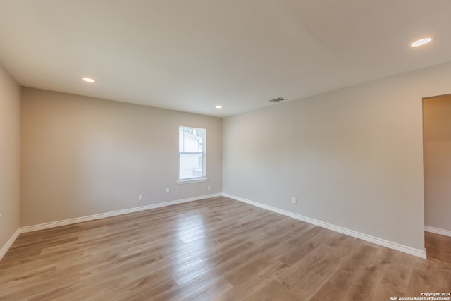 unfurnished room with light hardwood / wood-style floors