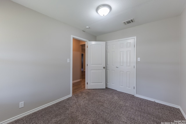 unfurnished bedroom featuring carpet floors and a closet