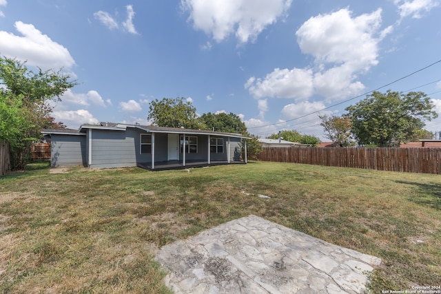 rear view of property with a patio area and a yard