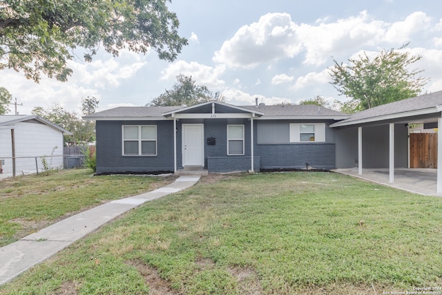 ranch-style house with a front yard and a carport