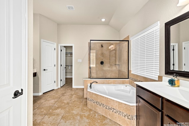 bathroom with vanity, lofted ceiling, independent shower and bath, and tile patterned floors