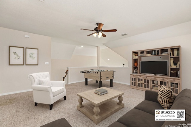 carpeted living room featuring ceiling fan