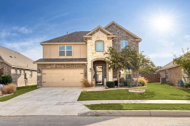 view of front of property with central air condition unit, a front yard, and a garage