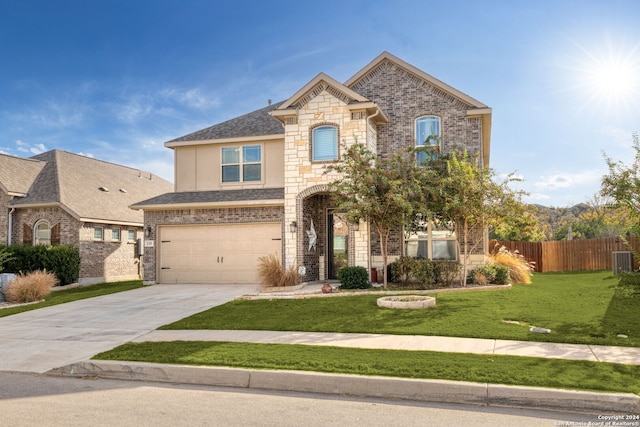 view of front of property with a front yard and a garage