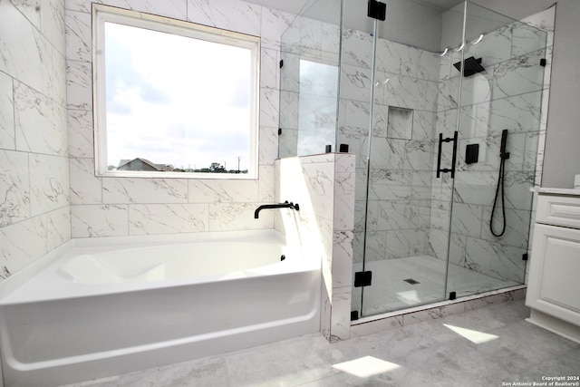 bathroom featuring vanity and shower with separate bathtub