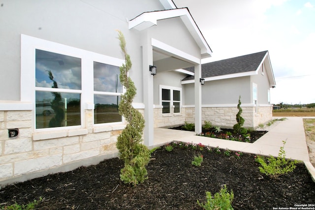 view of side of property with a patio area