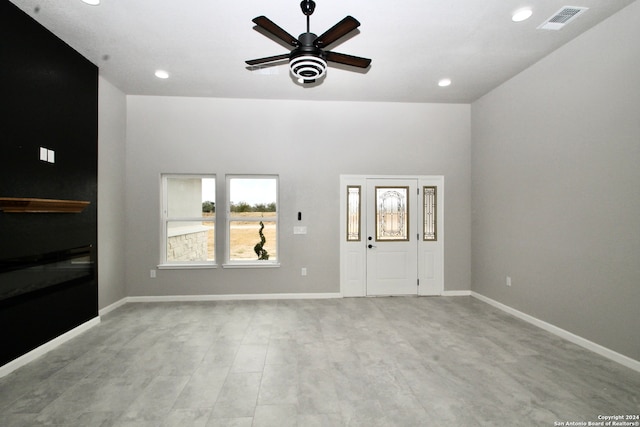 unfurnished living room featuring ceiling fan and light wood-type flooring