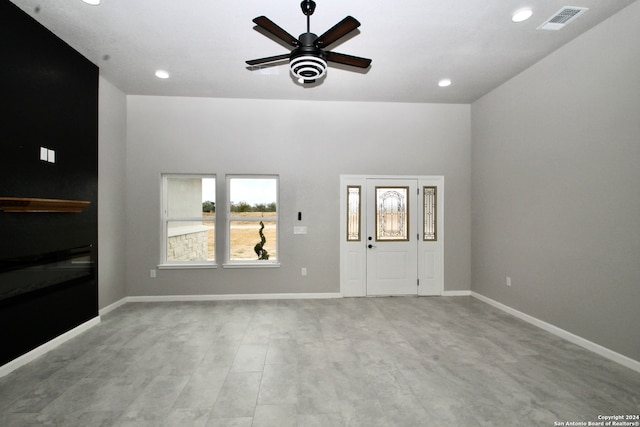 unfurnished living room with ceiling fan and light hardwood / wood-style floors