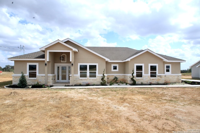 view of front facade featuring french doors and a front yard