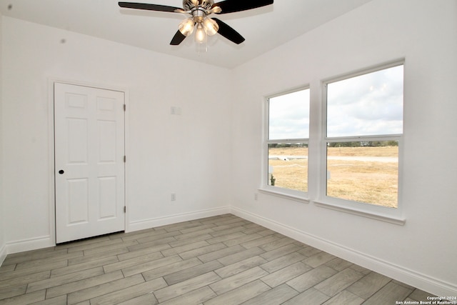 empty room featuring ceiling fan and light hardwood / wood-style floors