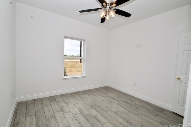 spare room featuring ceiling fan and light hardwood / wood-style flooring