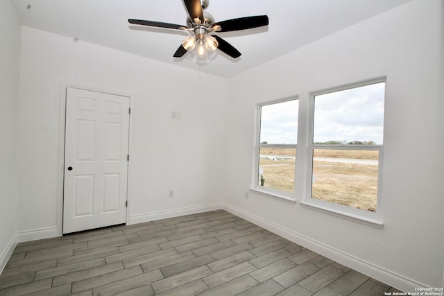 empty room featuring ceiling fan and light wood-type flooring