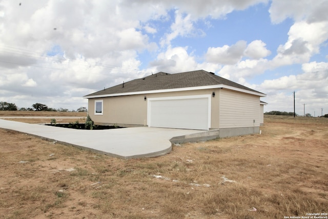 view of side of home with a garage