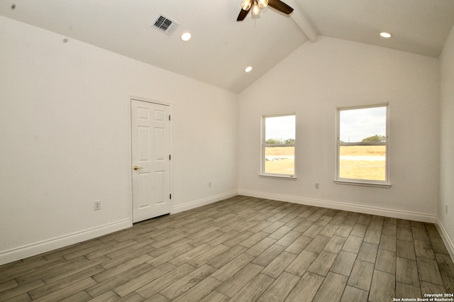 empty room featuring lofted ceiling with beams, light hardwood / wood-style floors, and ceiling fan