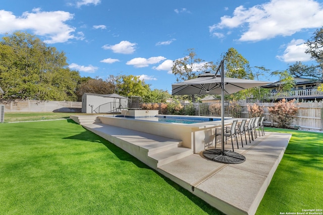 view of swimming pool with a storage unit, a yard, and a patio area