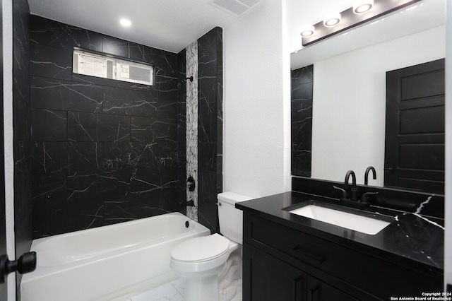 full bathroom with vanity, tiled shower / bath combo, and toilet