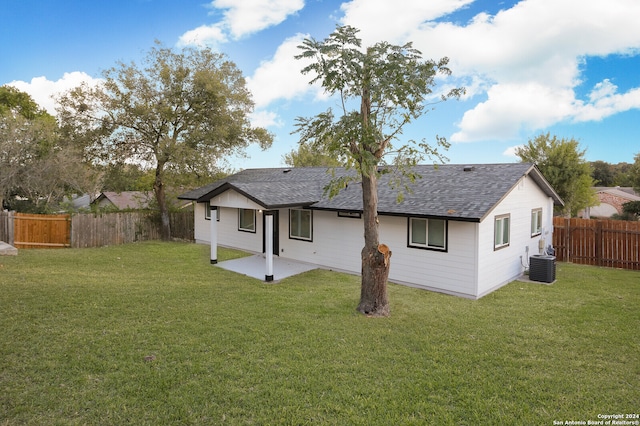 back of property with a patio area, a lawn, and cooling unit