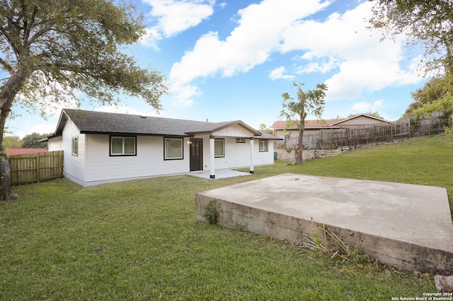 back of property featuring a patio and a lawn